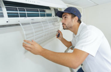 person performing an air conditioning repair
