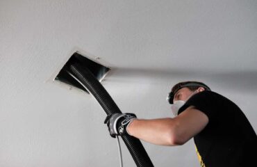 person performing air duct cleaning