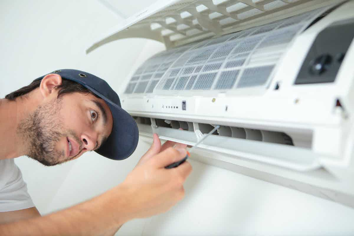 Man performing AC Repair